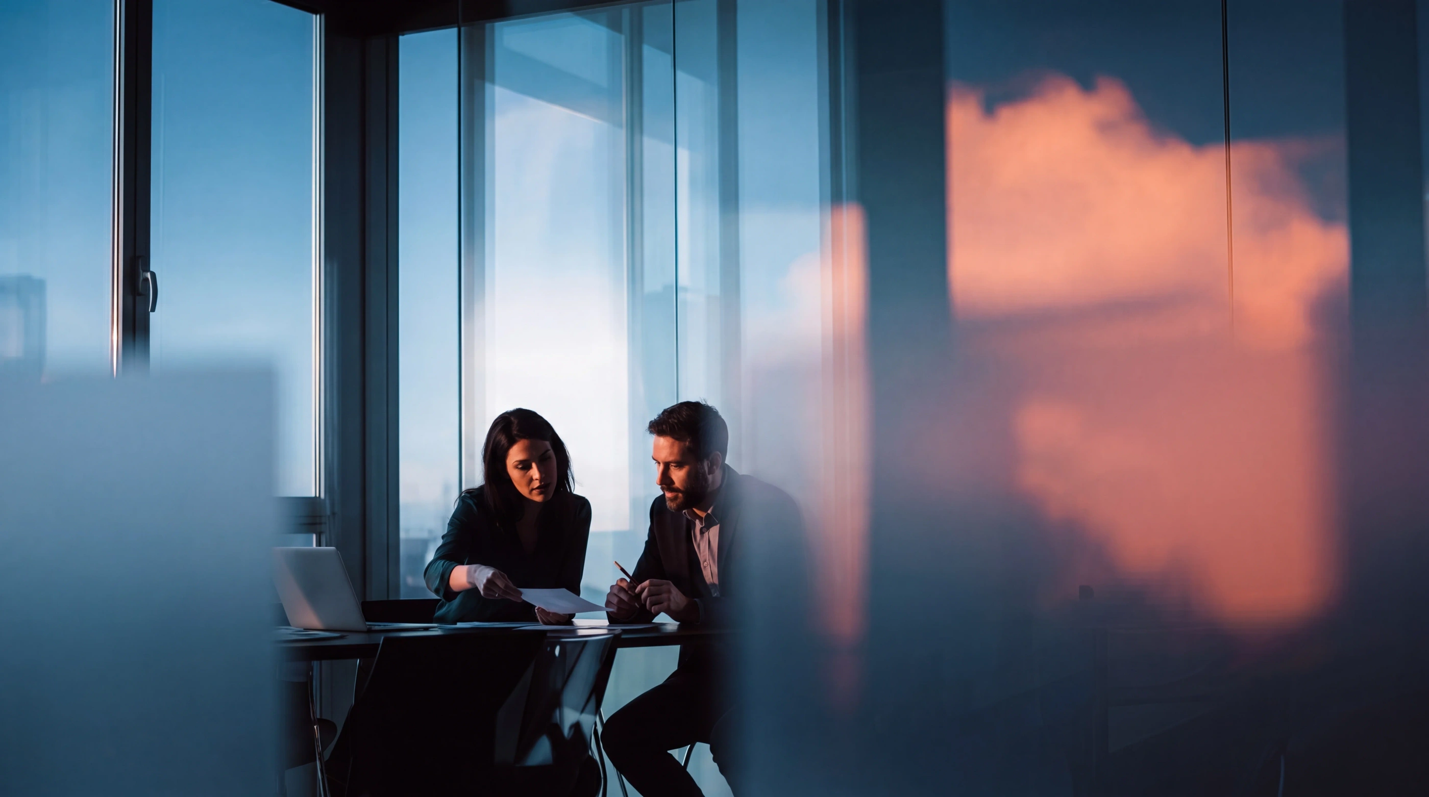 Silhouettes of professionals against a bright sky, illustrating coordinated software maintenance and support
