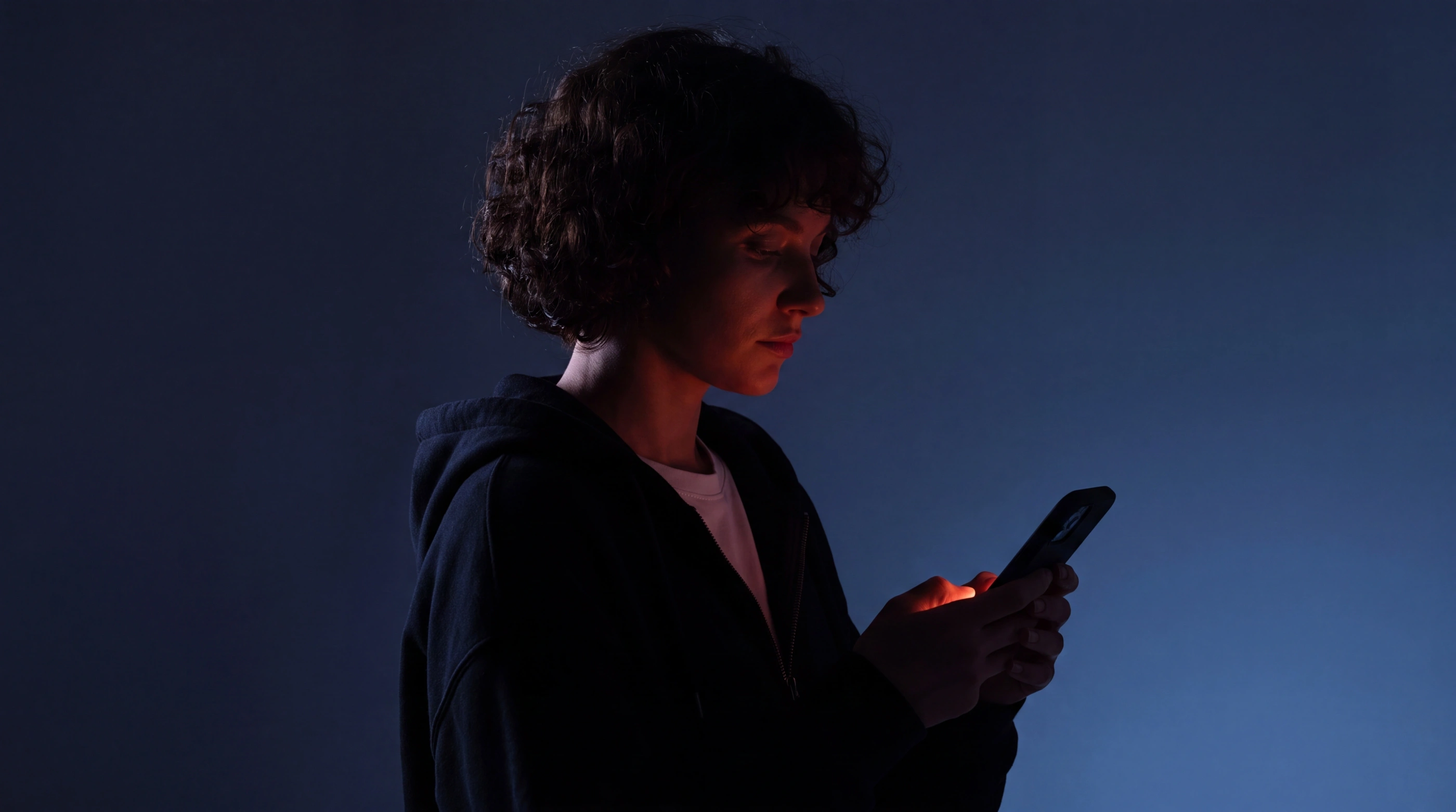 Professional using a secure mobile client portal in a dark workspace